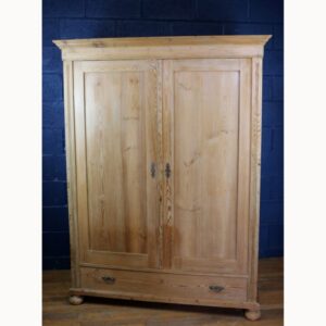 An Antique Rustic Farmhouse Pine Double Wardrobe Raised on Bun Feet