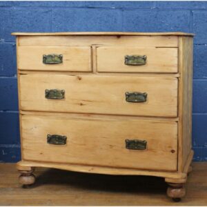 A Victorian Farmhouse Waxed Pine Two over Two Chest of Drawers Raised on Turned Bun Feet
