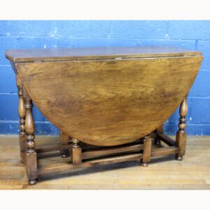 A Titchmarsh and Goodwin Solid Oak Dropleaf Dining Table Raised on Turned Supports