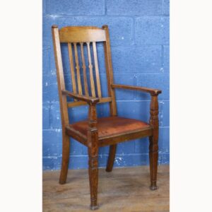 An Arts and Crafts Oak Open Arm Chair with Leather Seat