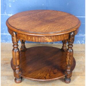 An Art Deco Carved Oak Circular Two Tier Occasional Coffee Table