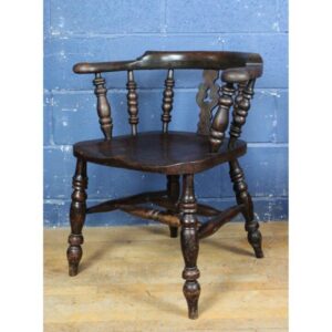 A Victorian Ash Smokers Bow Armchair Raised on Turned Supports
